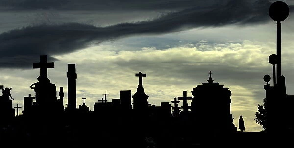 A woman walks along the tombs at the municipal cemetery of San Salvador in Oviedo