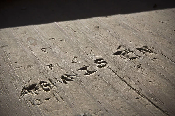 The word Afghanistan is carved into wood in a guard tower at Command Outpost AJK