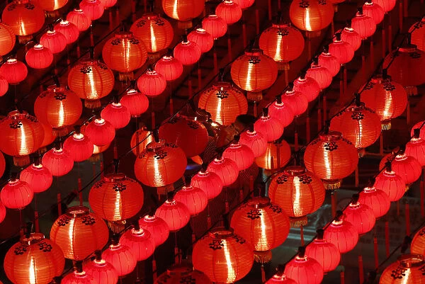 A worker changes light bulbs ahead of Chinese New Year celebrations at the Thean Hou