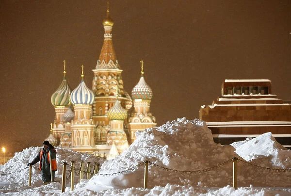 A worker clears and removes snow in Red Square in central Moscow