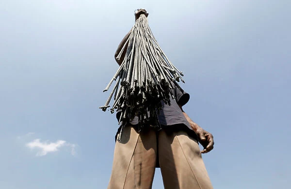 A worker holds wicks to dry at a factory ahead of Diwali, the Hindu festival of lights