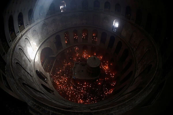 Worshippers hold candles as they take part in the Christian Orthodox Holy Fire ceremony