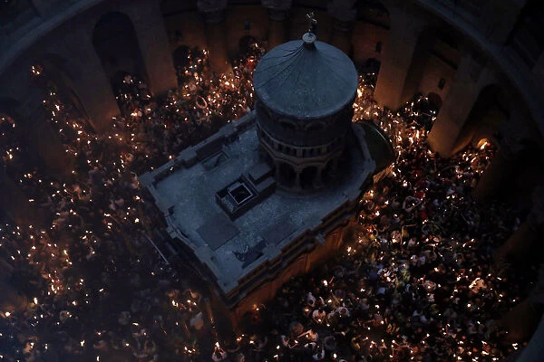 Worshippers hold candles as they take part in the Christian Orthodox Holy Fire ceremony