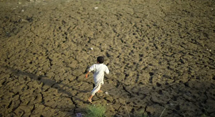 Framed Print : A young flood victim runs as he plays at a relief camp in Mohib Banda near Charsadda