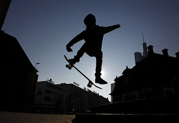 A young skateboarder performs a jump near the Hauptwache during a freezing cold