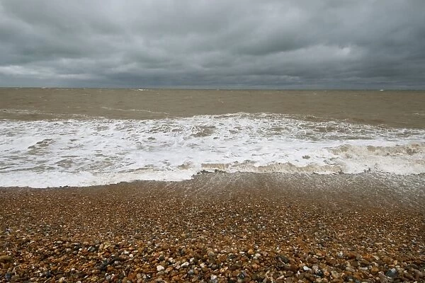 Waves crashing against shoreline of shingle beach, Dungeness, Kent, England, June