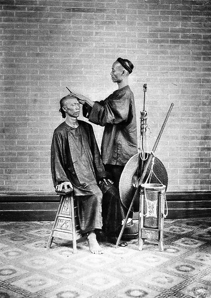 CHINA: BARBER, c1900. A street barber in China, c1900