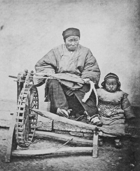 CHINA: COTTON SPINNING 1870s. A woman working a cotton spinning machine, China, 1870s
