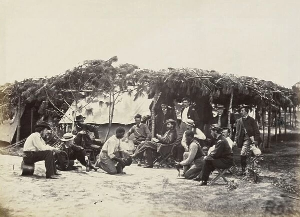 CIVIL WAR: COCKFIGHT, 1864. Union soldiers gathered around two African American men with roosters before a cock fight, at the headquarters of General Orlando B. Willcox during the siege of Petersburg, Virigina. Photographed by Timothy H. O Sullivan, August 1864