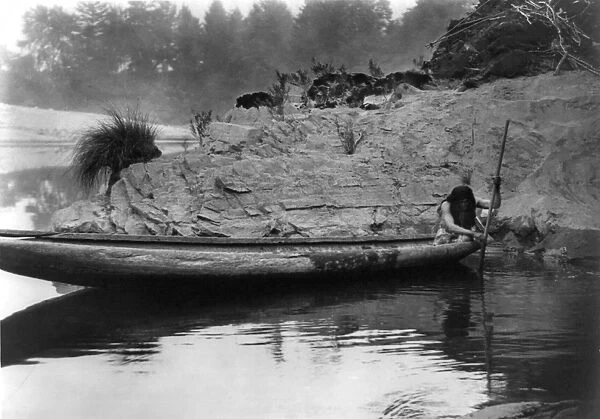 HUPA FISHERMAN, c1923. A Hupa Native American man fishing from a canoe in California