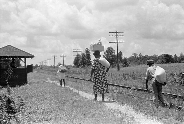 MISSISSIPPI: NATCHEZ, 1940. A family walking along the railroad tracks in Natchez, Mississippi