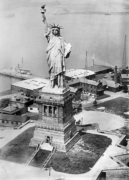 STATUE OF LIBERTY. The Statue of Liberty on Liberty Island in the New York Harbor seen from an army plane. Photograph, late 19th or early 20th century