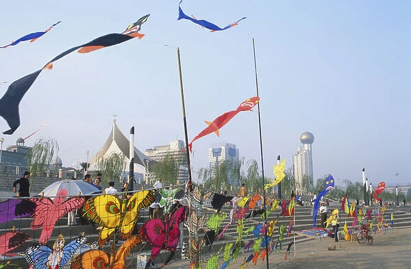 China, Hubei, Wuhan, Yangzi riverfront, colourful kites for sale blowing in the wind