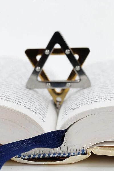 Close-up detail of a Torah in hebrew and a star of David. Jewish symbols