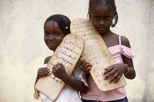 Islamic schoolgirls holding prayer tablets