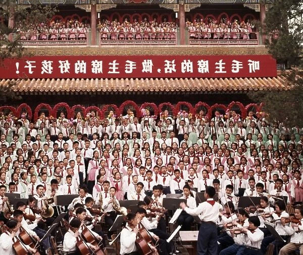 A mass chorus formed by peking (beijing) children singing the revolutionary song we are successors to communism at chingshan park in celebration of international labor day on may 1st (may day), the banner reads listen to chairman maos words, be chairman maos good children, 1965