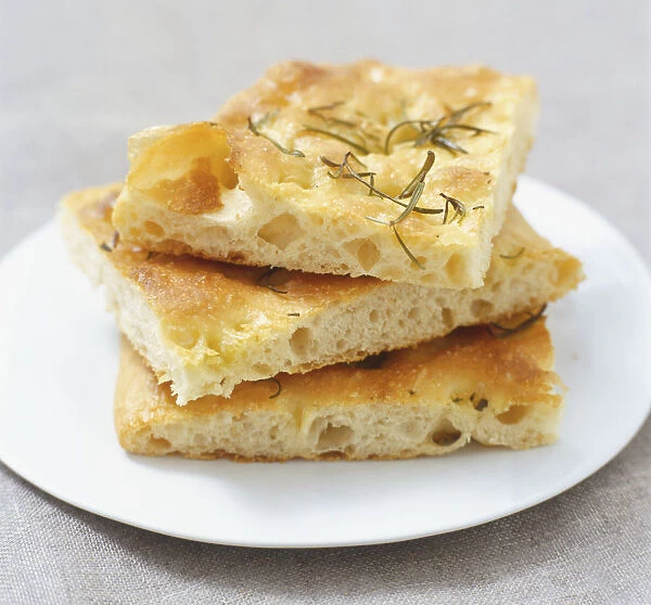 Three pieces of Foccaccia bread stacked on a plate