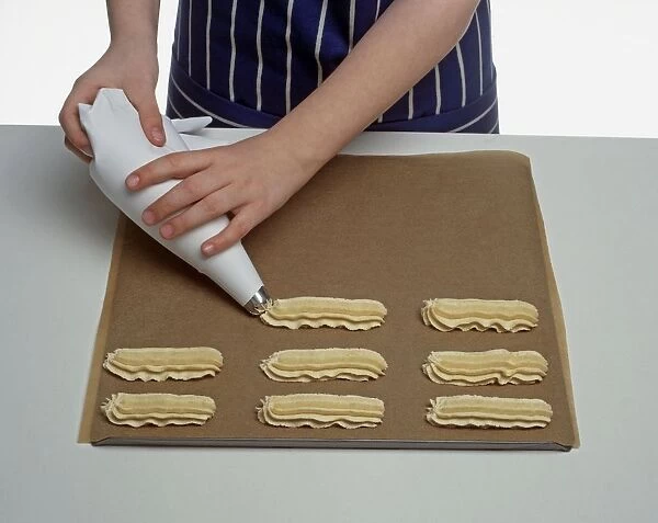 Piping biscuit dough out onto a baking sheet