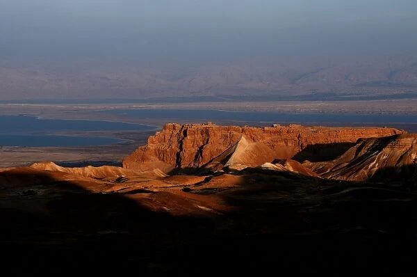 General view of Masada an ancient fortification situated on top of an isolated rock plateau on the eastern edge of the Judaean Desert, overlooking the Dead Sea in Israel