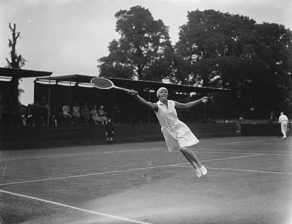 Surrey tennis championship at Surbiton. Miss Tapscott ( South Africa ) makes a leap for the ball