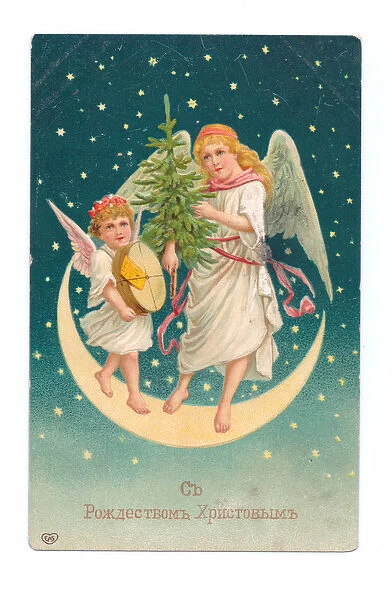 Edwardian postcard of two angels standing on a crescent moon holding a Christmas tree, c