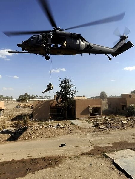 A pararescueman rappels from an HH-60 Pavehawk helicopter