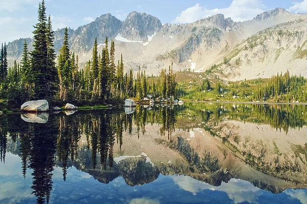 Eaglecap Wilderness, Oregon, United States Of America; Reflections Of The Trees And Mountains In Blue Lake