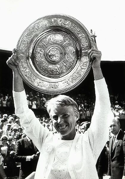 Ann Jones tennis player with Wimbledon womens trophy held above head after beating Billie