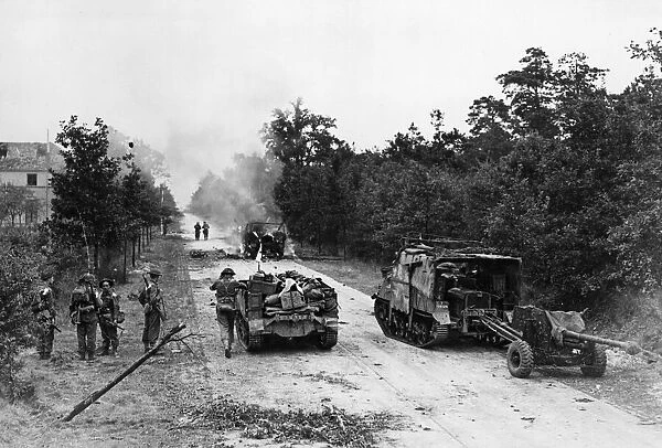 British armoured vehicles on fire in the early stages of the Allied air