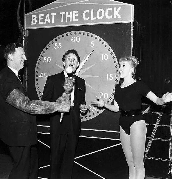 Bruce Forsyth Entertainer standing in front of Beat The Clock