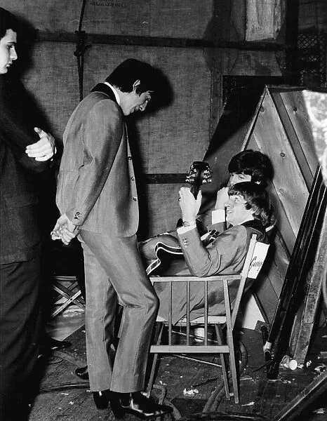 George Harrison, RingoStarr (holding Georges 12-string Rickenbacker guitar