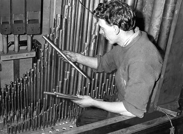 Mr. Gordon Pratt replacing some organ pipes in May 1957. 08  /  05  /  57