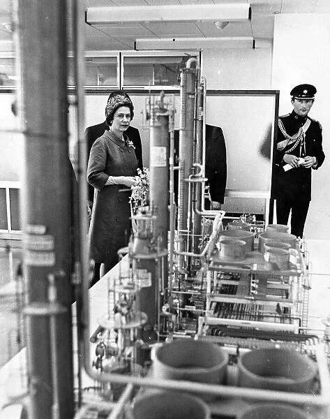 Queen Elizabeth II looks at a model of the new refinery at Milford Haven