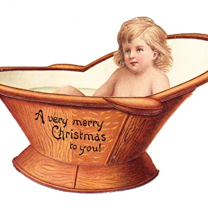 Baby in a hip bath on a cutout Christmas card