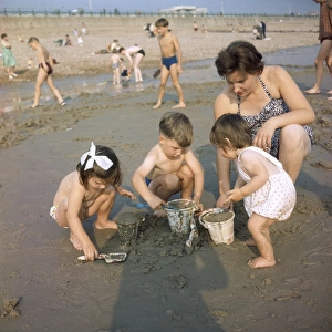Mother and children on a sandy beach