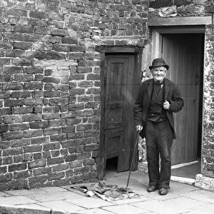 Old man outside house