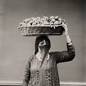 Orange merchant - woman with a basket of fruit Egypt