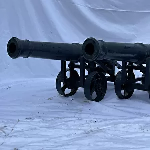Pair of cast iron cannon on carriages