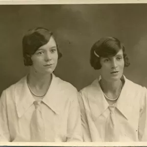 Studio portrait of two women, both with their dark hair bobbed