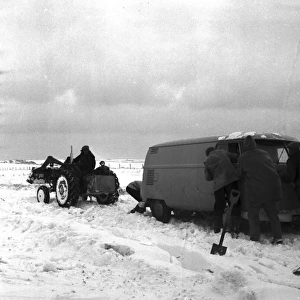 Van and snow plough in the snow