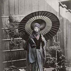Young Japanese woman in winter costume with umbrella