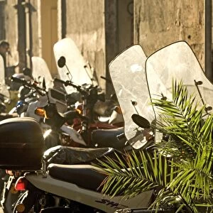 Italy - Rome - street scene with parked mopeds in sunlight