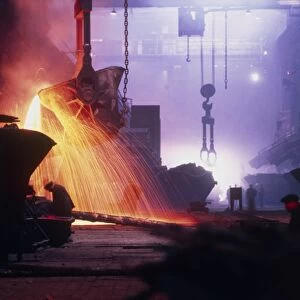 Sparks fly in a foundry during copper smelting