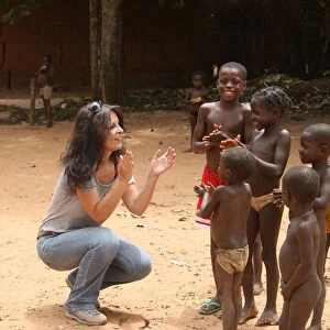 French woman playing wih African children, Tori, Benin, West Africa, Africa