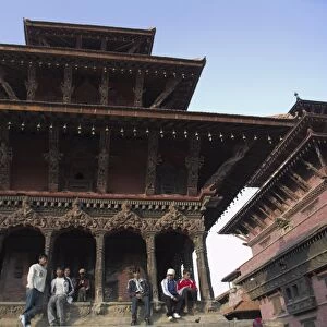 Local people sitting on temple steps