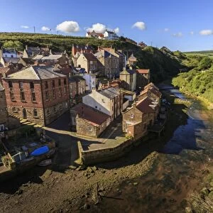 Steep streets of fishing village nd river, elevated view in summer, Staithes, North