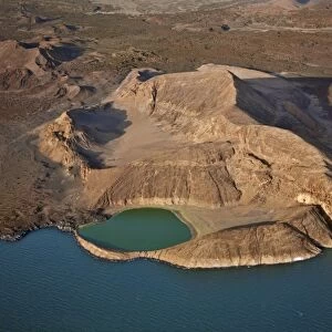 An extinct volcanic crater, Abil Agituk, at the southern end of Lake Turkana has a distinctively green crater lake which is fed by underground seepage from the