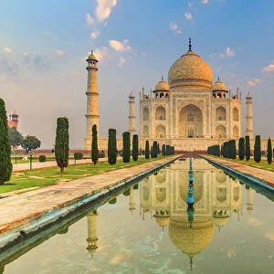 India, Taj Mahal mausoleum in the early morning reflecting in the water pool