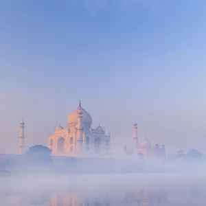 India, Taj Mahal reflecting in the Yamuna river on a foggy morning