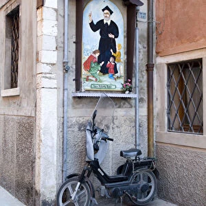 Scooter and relgious wall mural, Chioggia, Venice, Veneto, Italy